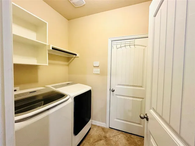 a utility room with washer and dryer