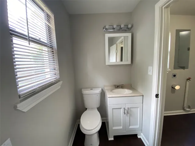 a bathroom with a toilet sink and mirror