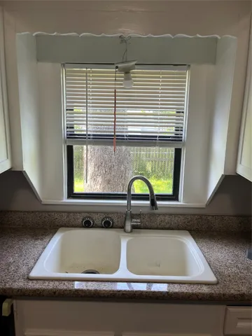a close view of sink and a microwave oven