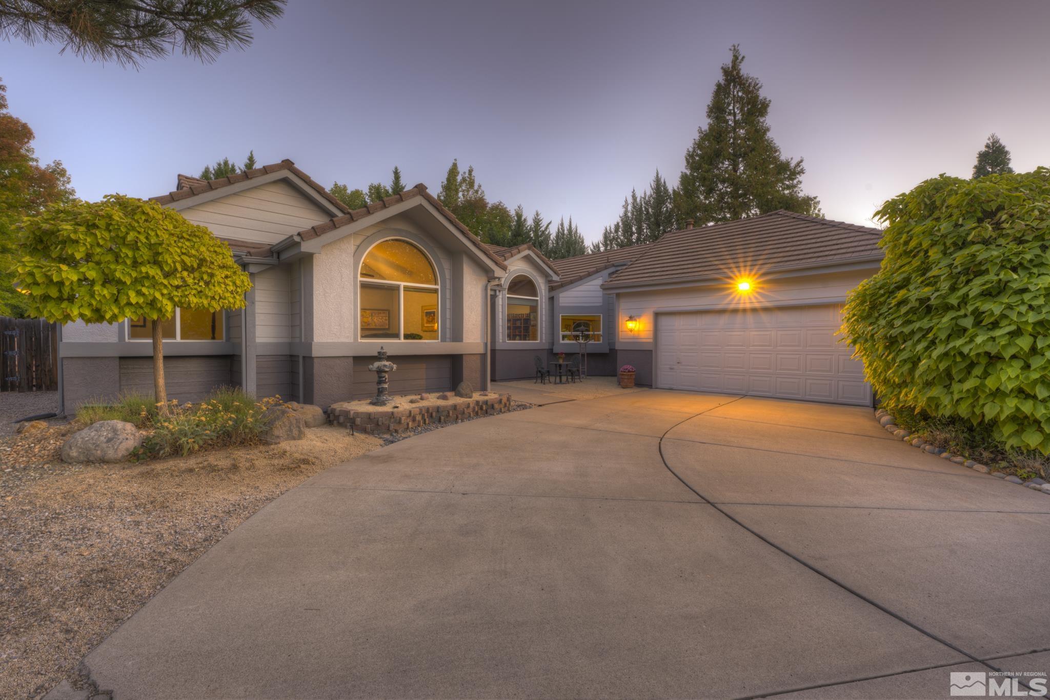14095 Riata Circle Reno, NV 89521 - Photo 1 of 26 a front view of a house with a yard and garage
