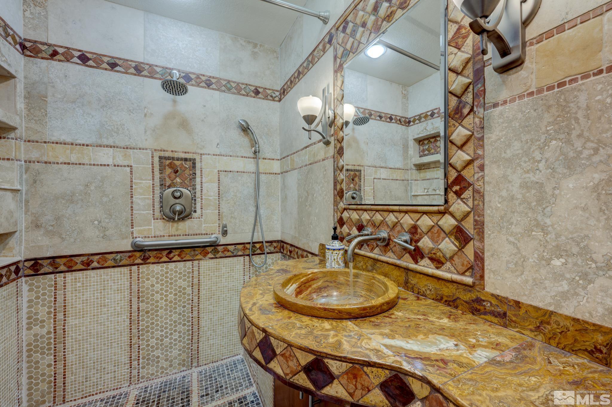 14095 Riata Circle Reno, NV 89521 - Photo 13 of 26 a bathroom with a sink and a mirror