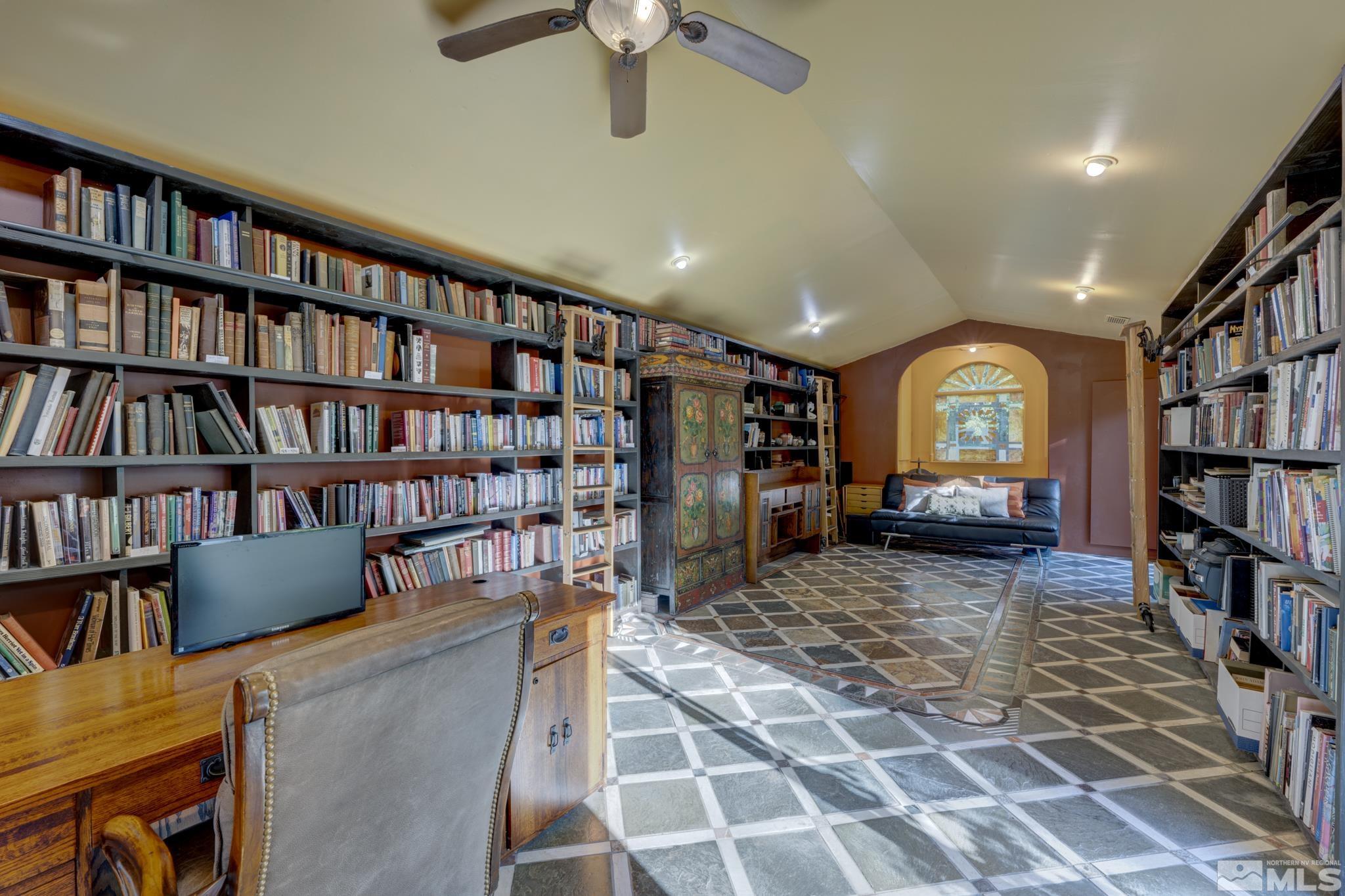 14095 Riata Circle Reno, NV 89521 - Photo 17 of 26 a living room with a book shelf and a book shelf