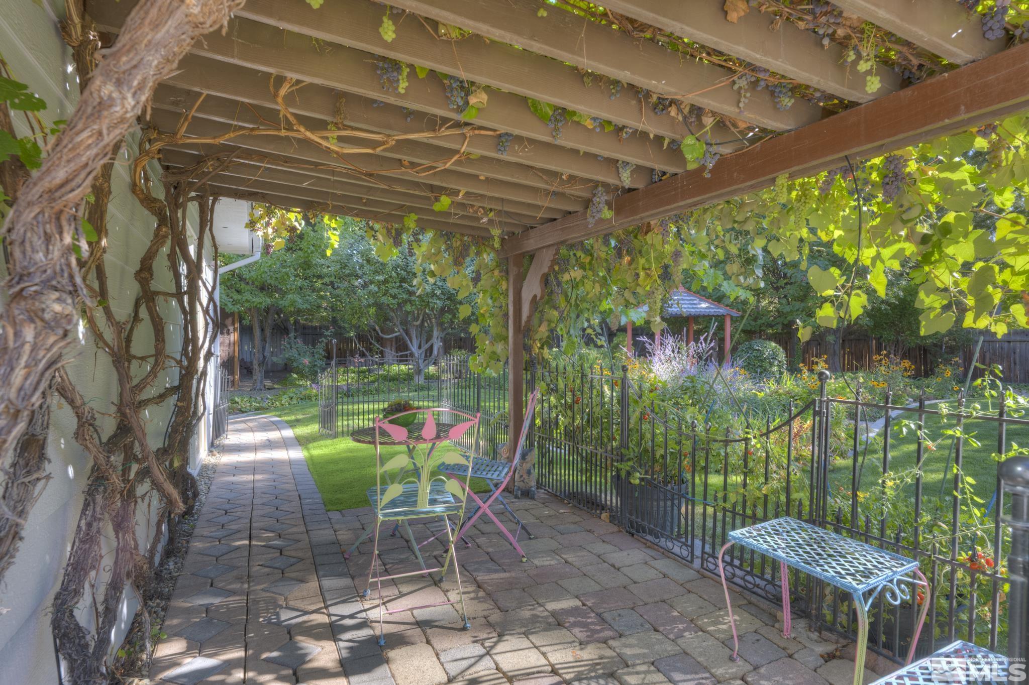 14095 Riata Circle Reno, NV 89521 - Photo 20 of 26 a backyard of a house with lots of green space and glass windows