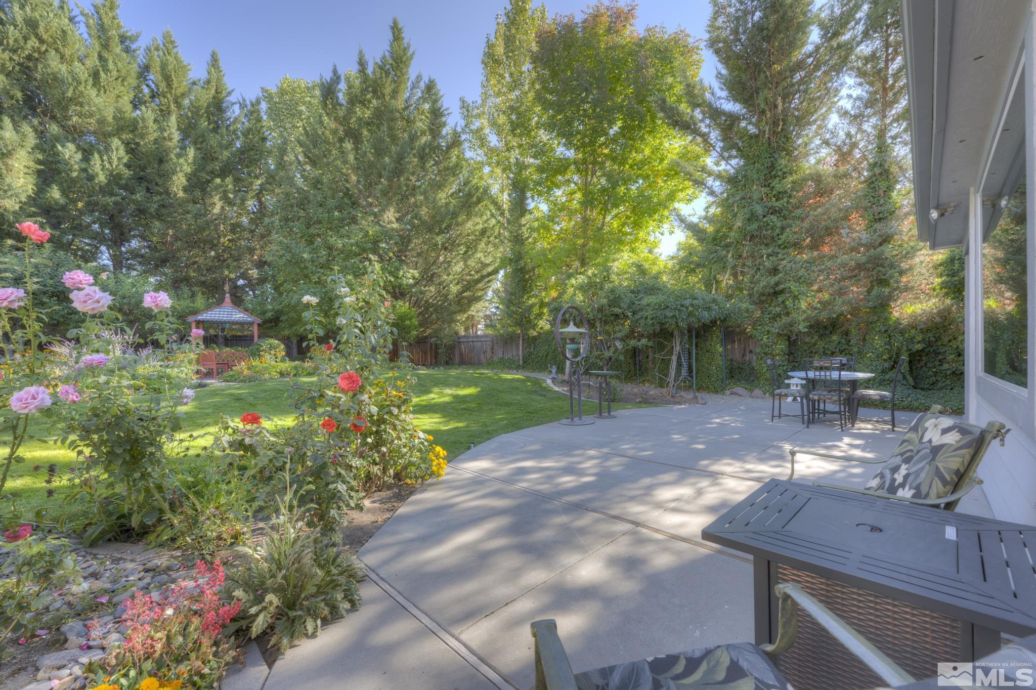 14095 Riata Circle Reno, NV 89521 - Photo 24 of 26 a view of yard with seating space and trees in the background