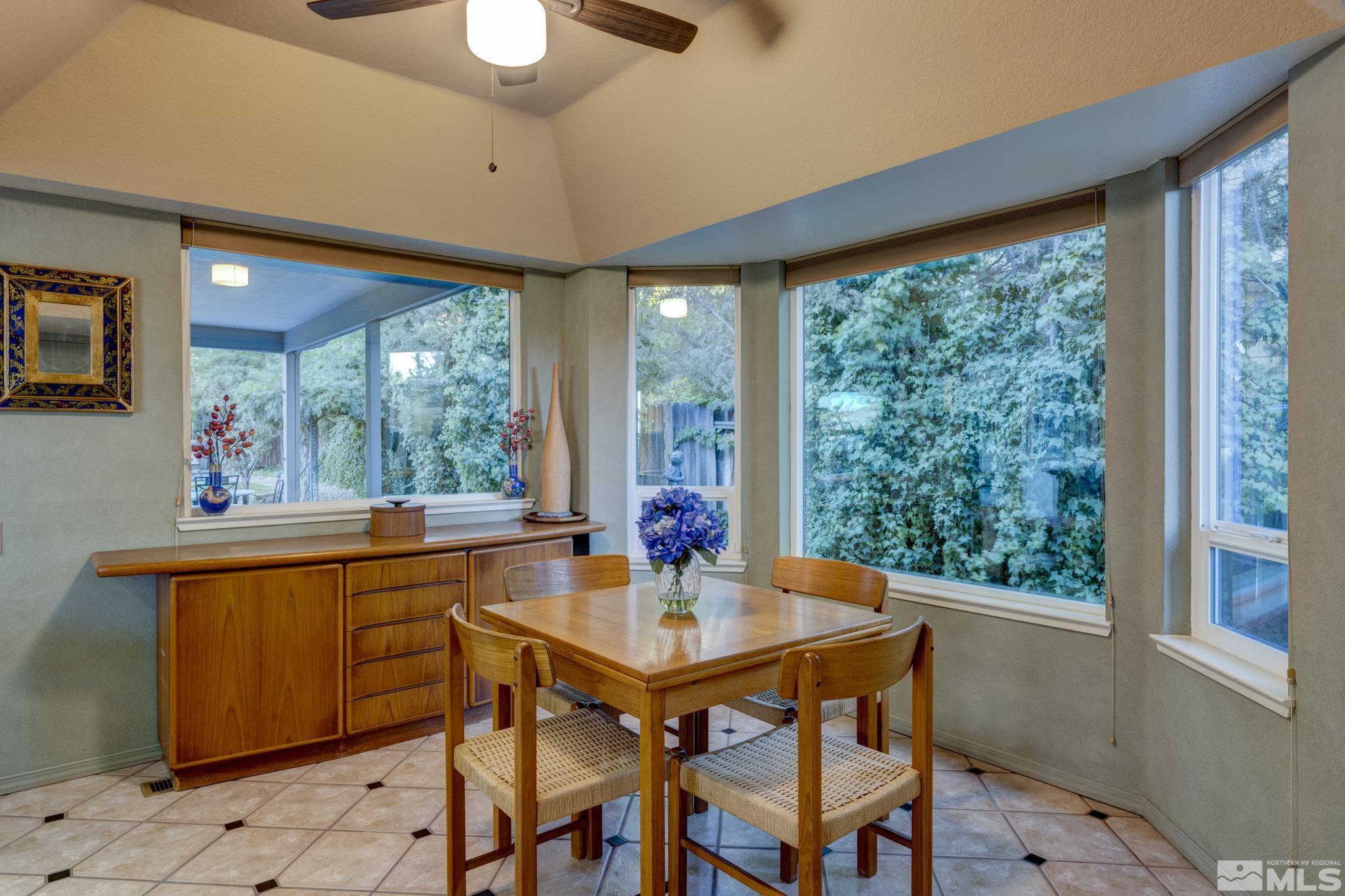 14095 Riata Circle Reno, NV 89521 - Photo 7 of 26 a dining room with furniture a chandelier and wooden floor