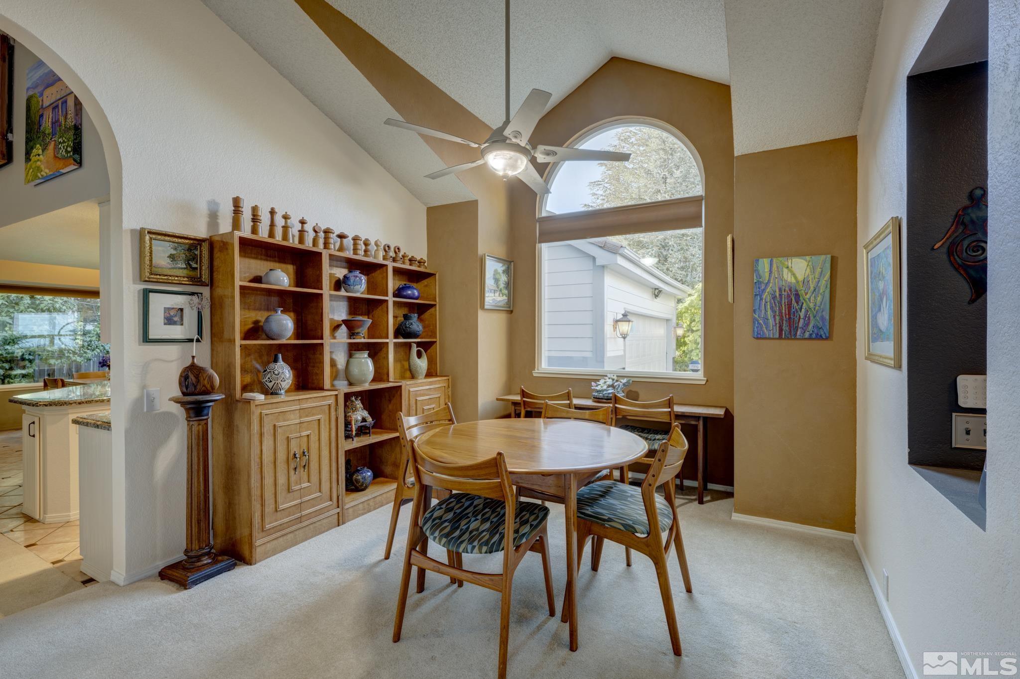 14095 Riata Circle Reno, NV 89521 - Photo 9 of 26 a dining room with furniture and a chandelier