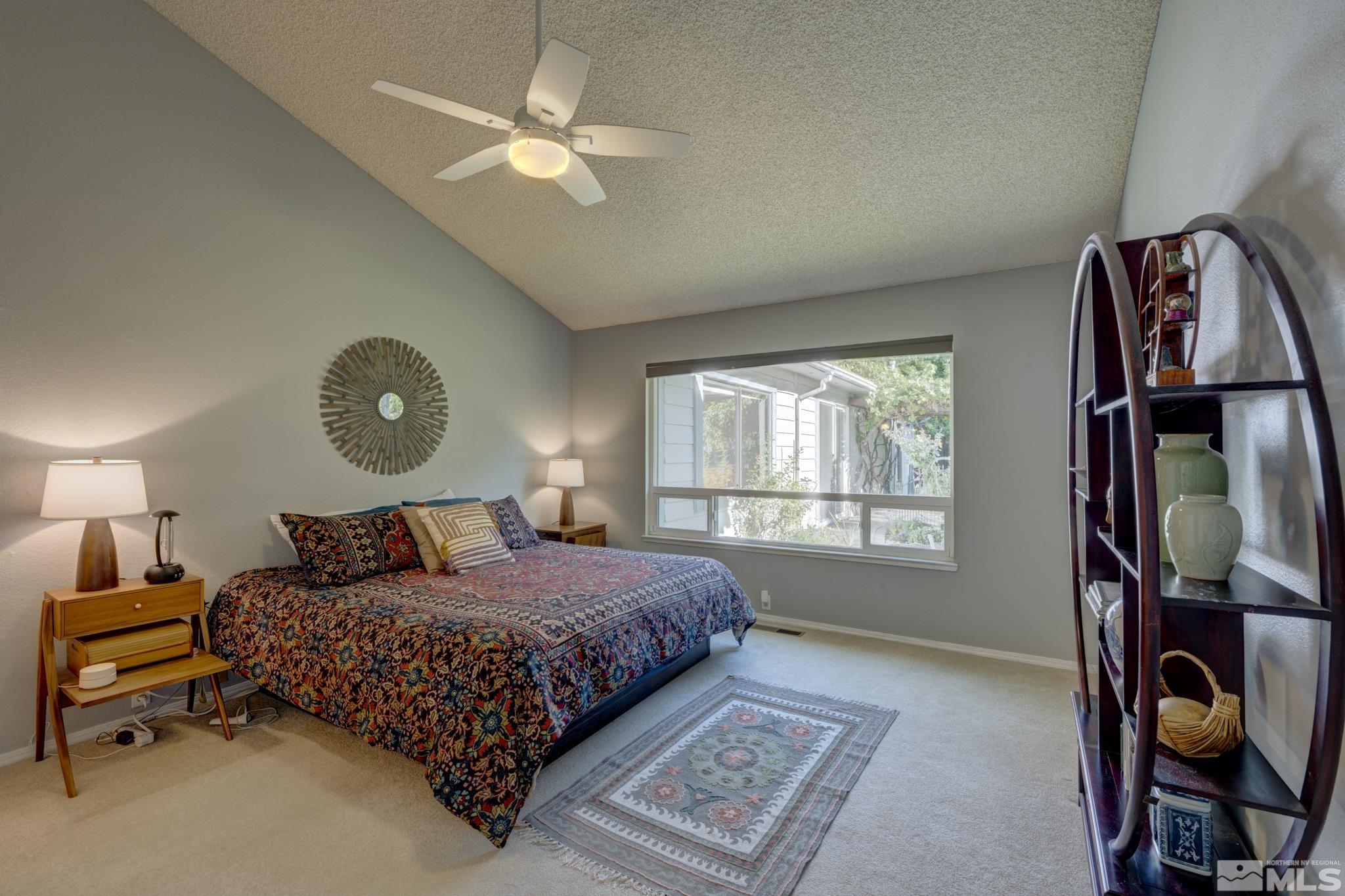 14095 Riata Circle Reno, NV 89521 - Photo 10 of 26 a bedroom with a bed a window and dresser