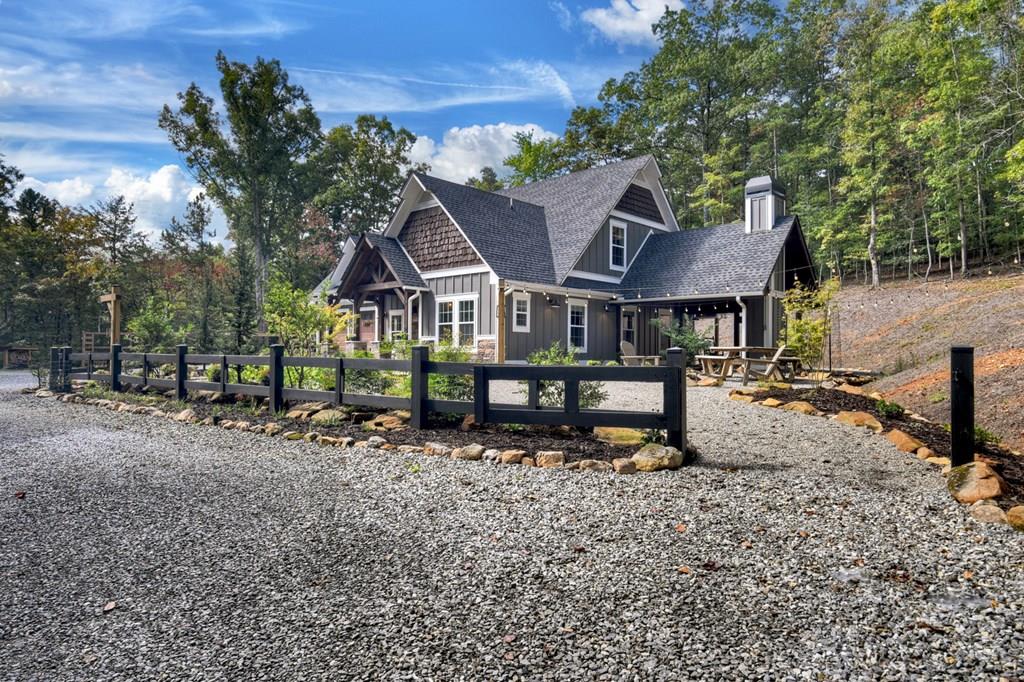 a view of a house with a yard and sitting area