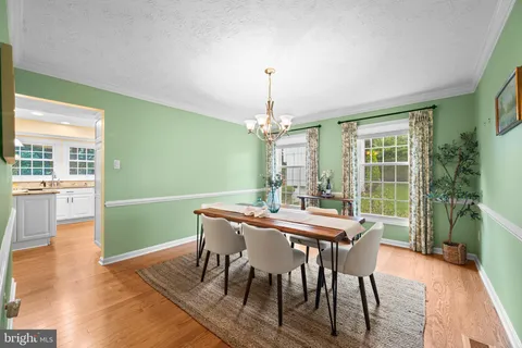 a dining room with furniture a rug and a chandelier