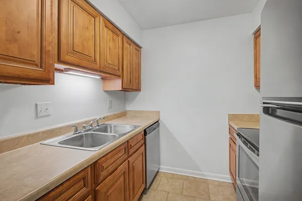 a kitchen with a sink stove and microwave