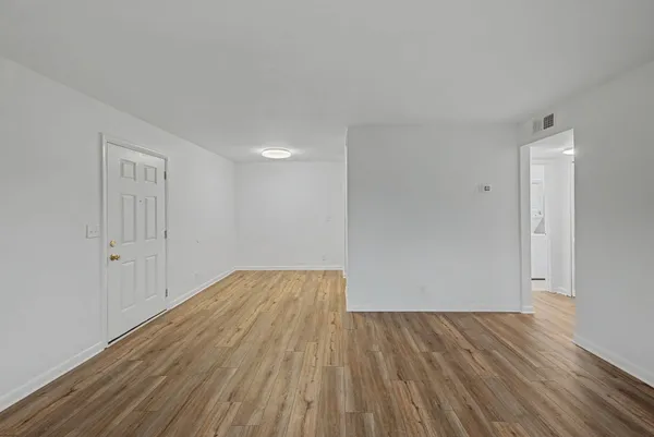 a view of a hallway with wooden floor