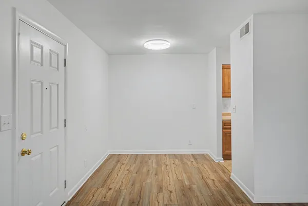 a view of a kitchen with a sink and refrigerator