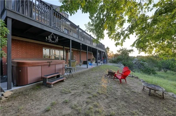 a backyard of a house with table and chairs