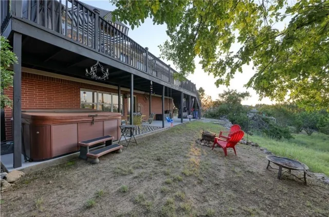 a backyard of a house with table and chairs