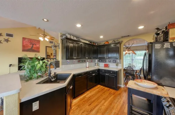 a kitchen with a sink and lots of counter top space