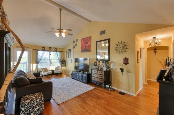 a living room with furniture fireplace and a large window