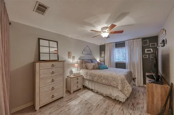 a bedroom with a bed and a chandelier
