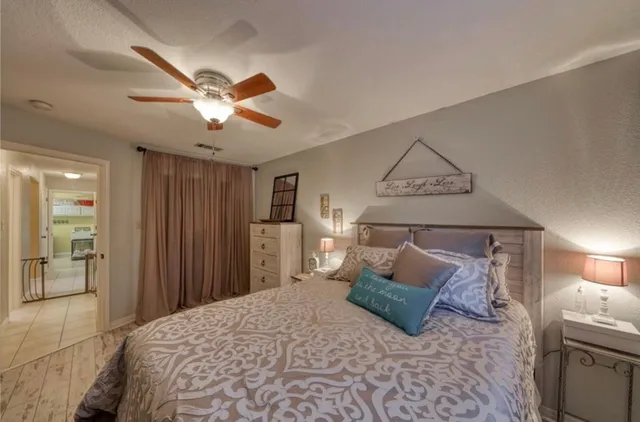 a bedroom with a bed and a chandelier