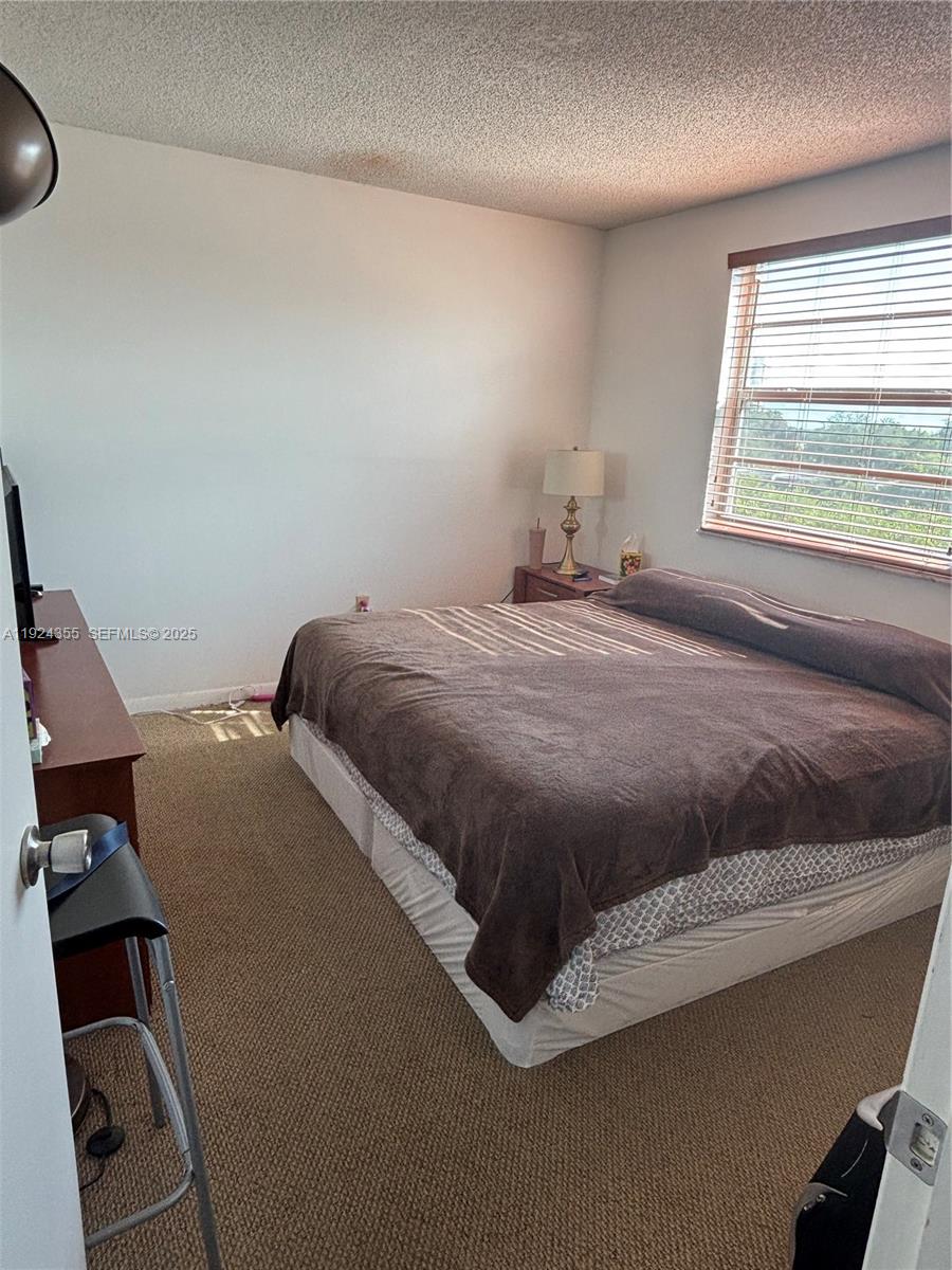 14250 Southwest 62nd Street, Unit 520 Miami, FL 33183 - Photo 13 of 39 a bedroom with a bed and window