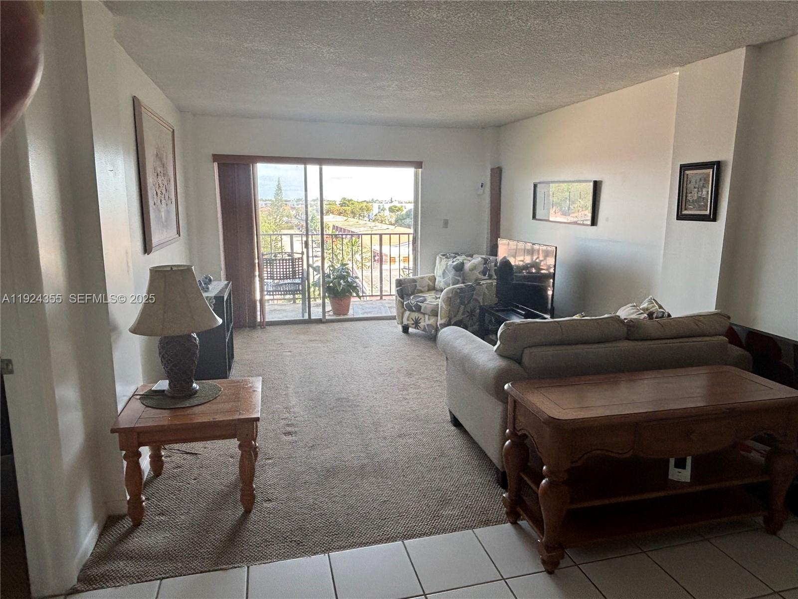 14250 Southwest 62nd Street, Unit 520 Miami, FL 33183 - Photo 7 of 39 a living room with furniture and a window
