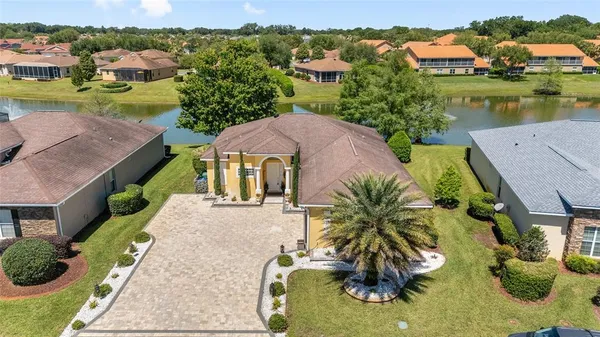 an aerial view of a house with garden space and ocean view