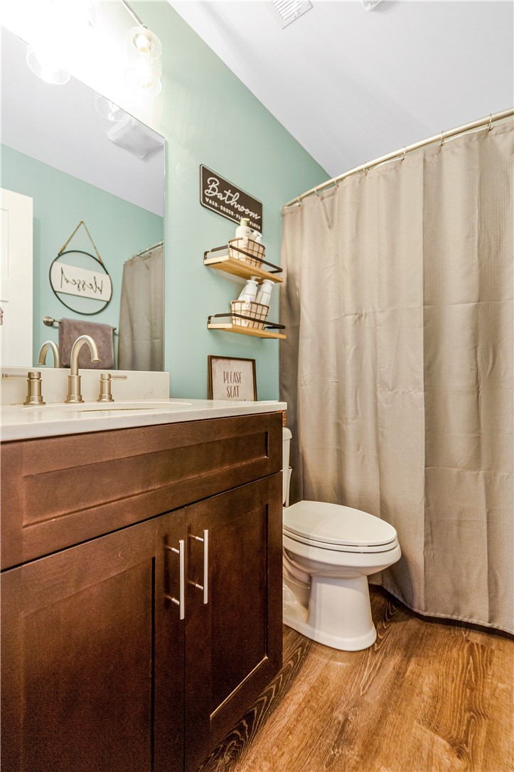 842 Conneross Road Townville, SC 29689 - Photo 20 of 34 A well-appointed bathroom offers wood-look flooring and a functional vanity with ample storage.