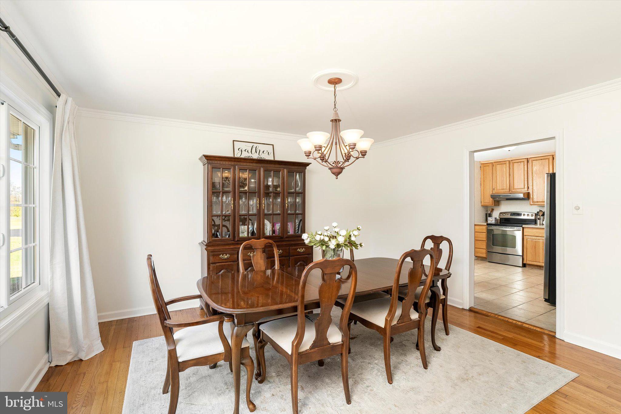 21 Holmes Mill Road Cream Ridge, NJ 08514 - Photo 11 of 37 a view of a dining room with furniture wooden floor and chandelier
