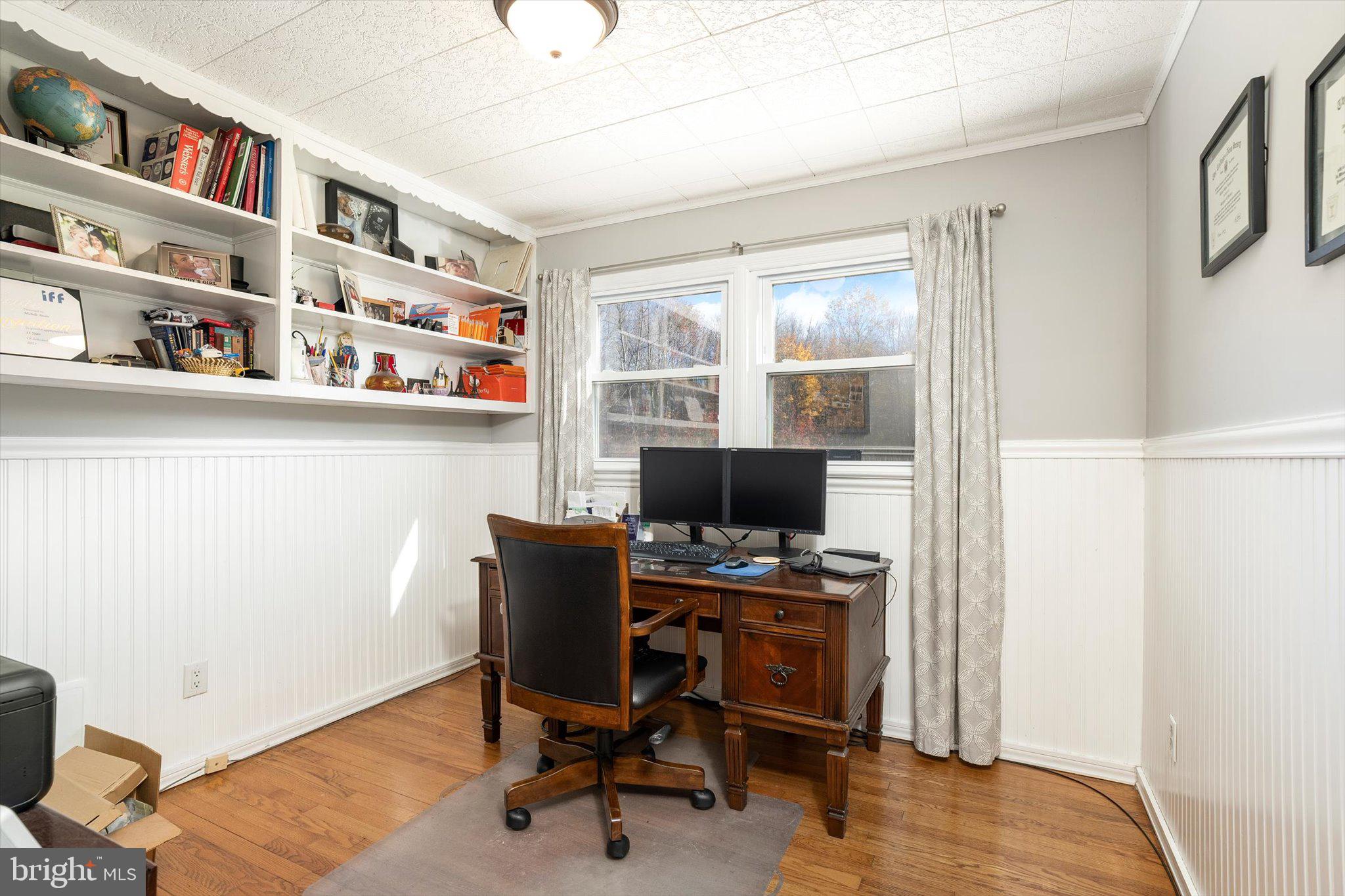 21 Holmes Mill Road Cream Ridge, NJ 08514 - Photo 18 of 37 a view of a workspace with furniture and a bookshelf