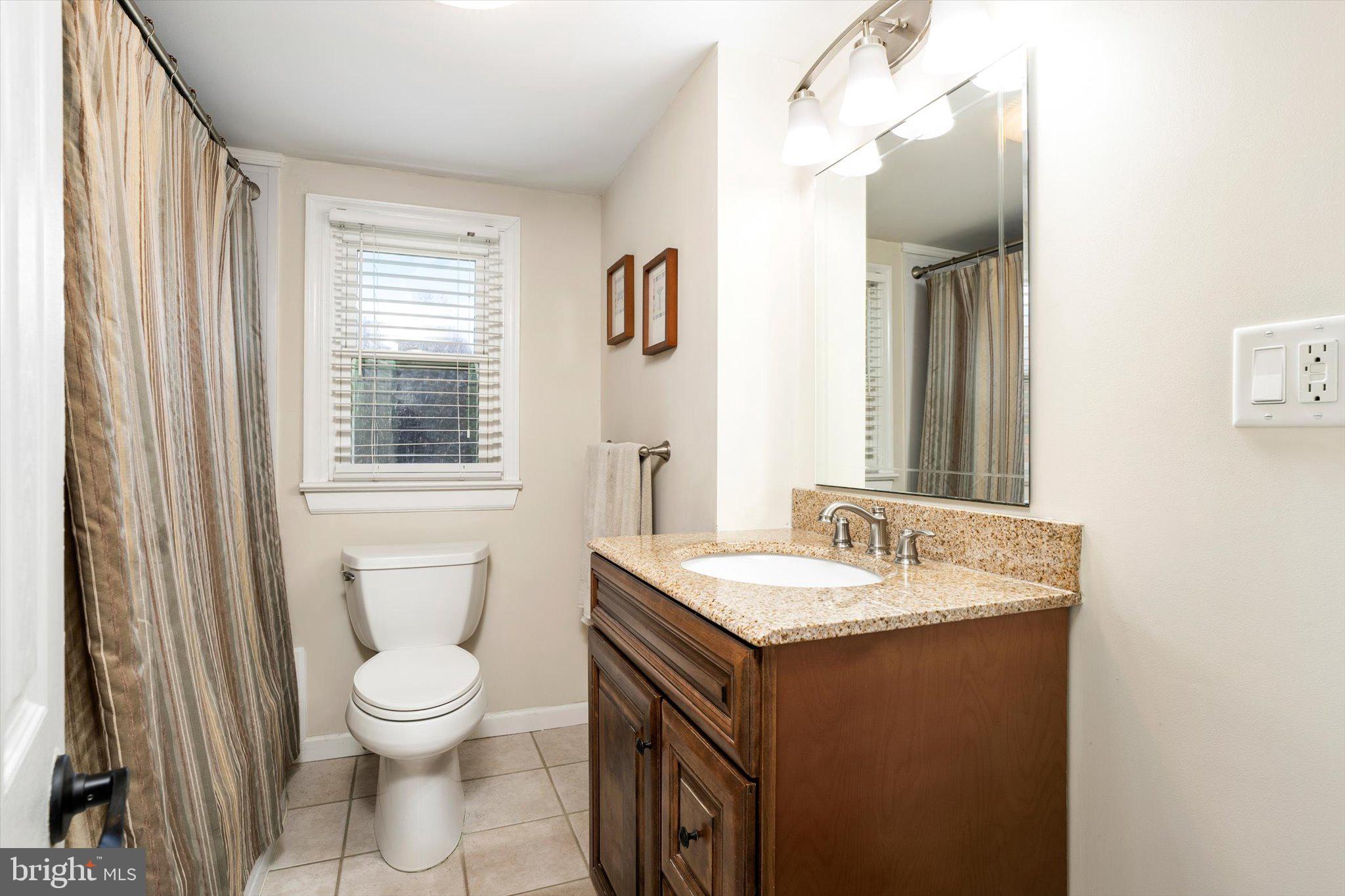 21 Holmes Mill Road Cream Ridge, NJ 08514 - Photo 25 of 37 a bathroom with a granite countertop sink a toilet and a mirror