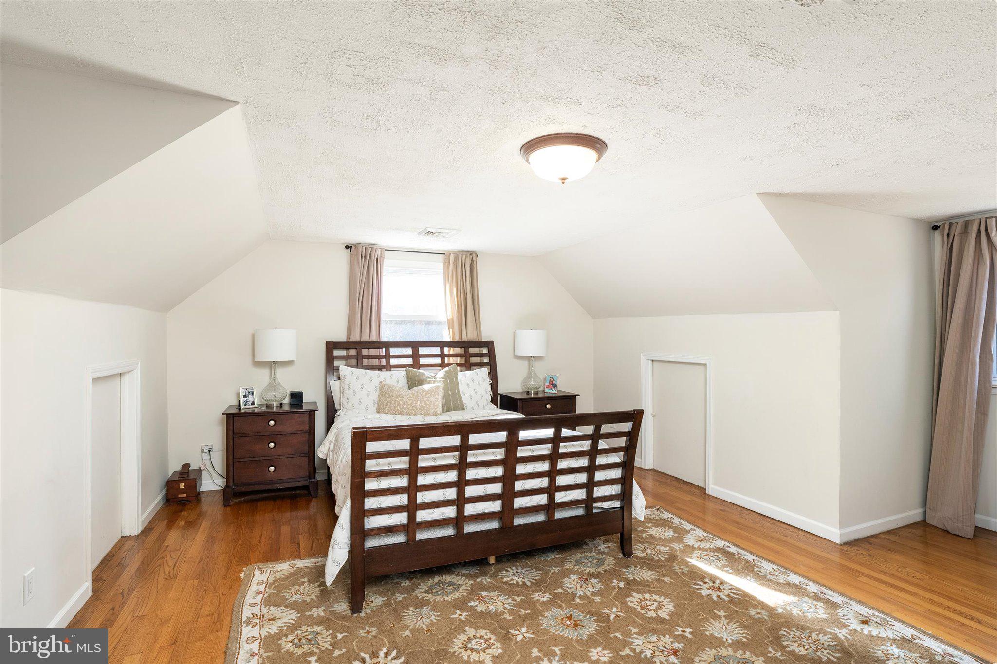 21 Holmes Mill Road Cream Ridge, NJ 08514 - Photo 26 of 37 a bedroom with a bed and a chandelier