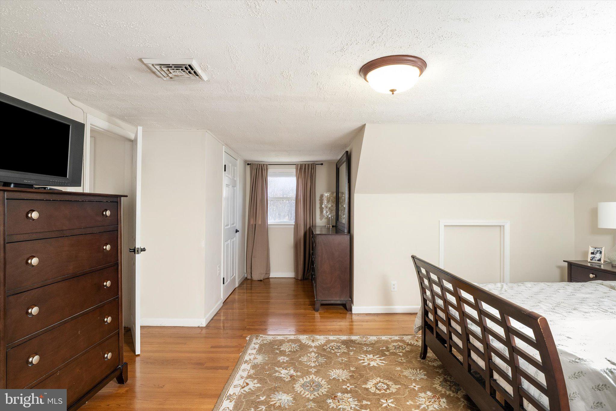 21 Holmes Mill Road Cream Ridge, NJ 08514 - Photo 27 of 37 a bedroom with a bed and a television