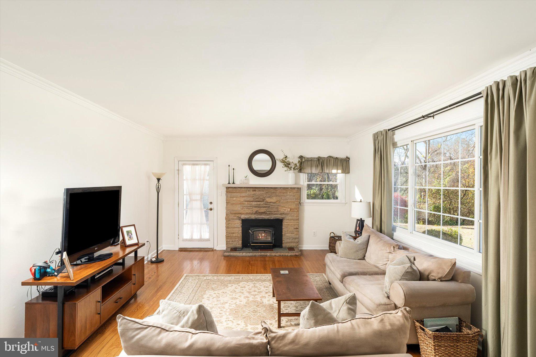21 Holmes Mill Road Cream Ridge, NJ 08514 - Photo 6 of 37 a living room with furniture a flat screen tv and a fireplace