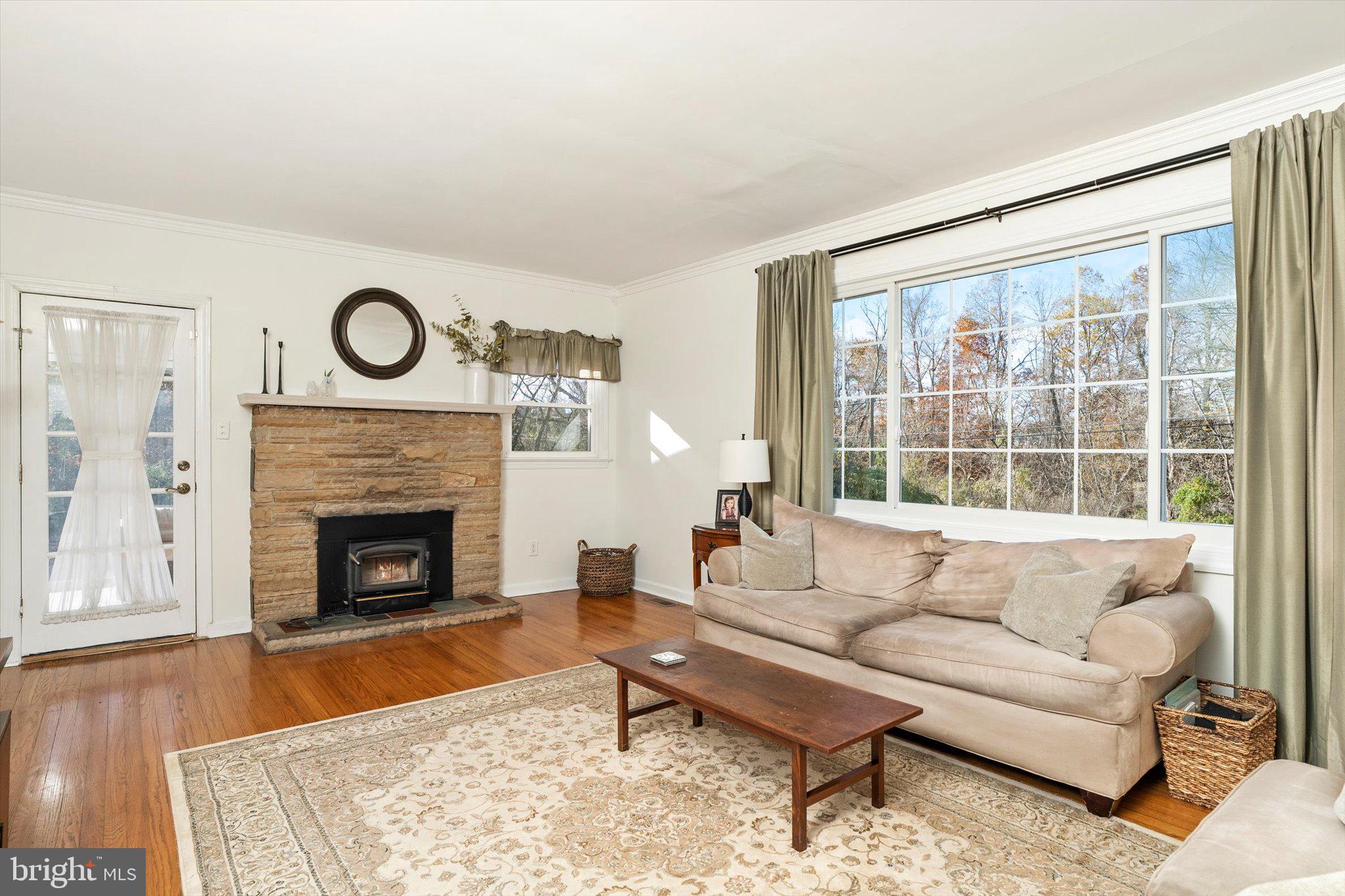 21 Holmes Mill Road Cream Ridge, NJ 08514 - Photo 7 of 37 a living room with furniture a fireplace and a large window