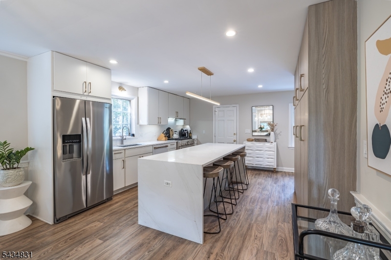 200 Wychwood Road Westfield, NJ 07090 - Photo 11 of 31 a kitchen with stainless steel appliances granite countertop a refrigerator a sink dishwasher a stove and a dining table with wooden floor