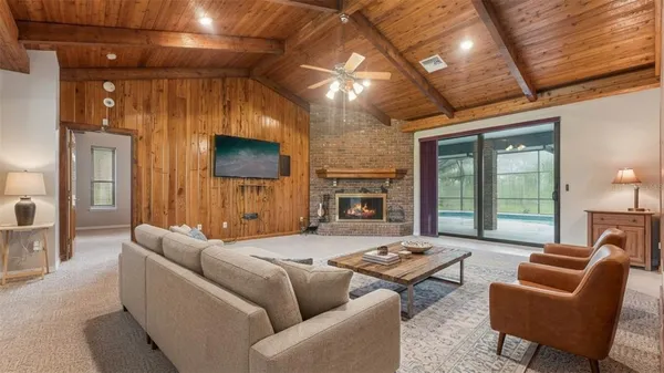 a view of a house with a yard and large trees