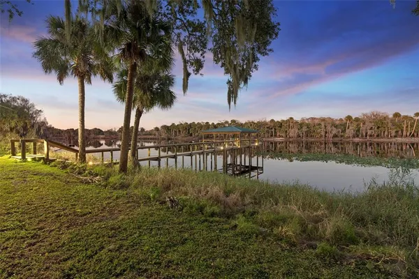 a view of a swimming pool with a yard in front of it