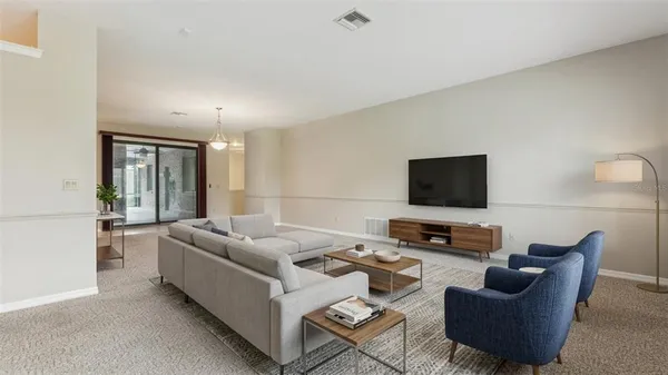 a living room with furniture pool table and a large window