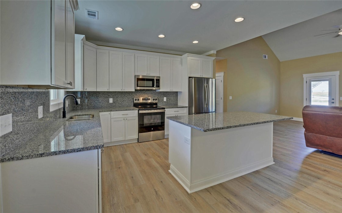 111 Topher Street Hartwell, GA 30643 - Photo 11 of 38 This functional kitchen features ample counter space and modern appliances, perfect for any culinary endeavor.
