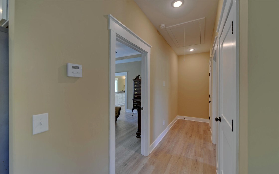 111 Topher Street Hartwell, GA 30643 - Photo 14 of 38 This interior hallway features sleek flooring and recessed lighting, offering a welcoming flow throughout the home.
