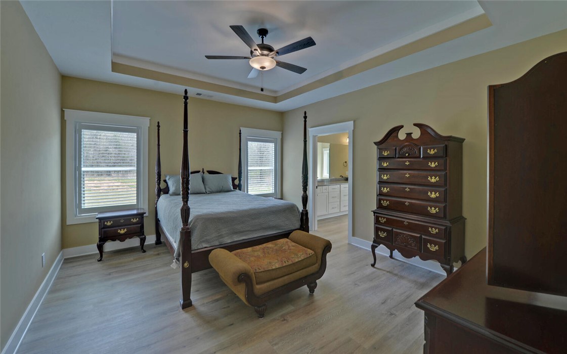 111 Topher Street Hartwell, GA 30643 - Photo 15 of 38 This primary bedroom features elegant tray ceilings and durable vinyl flooring.