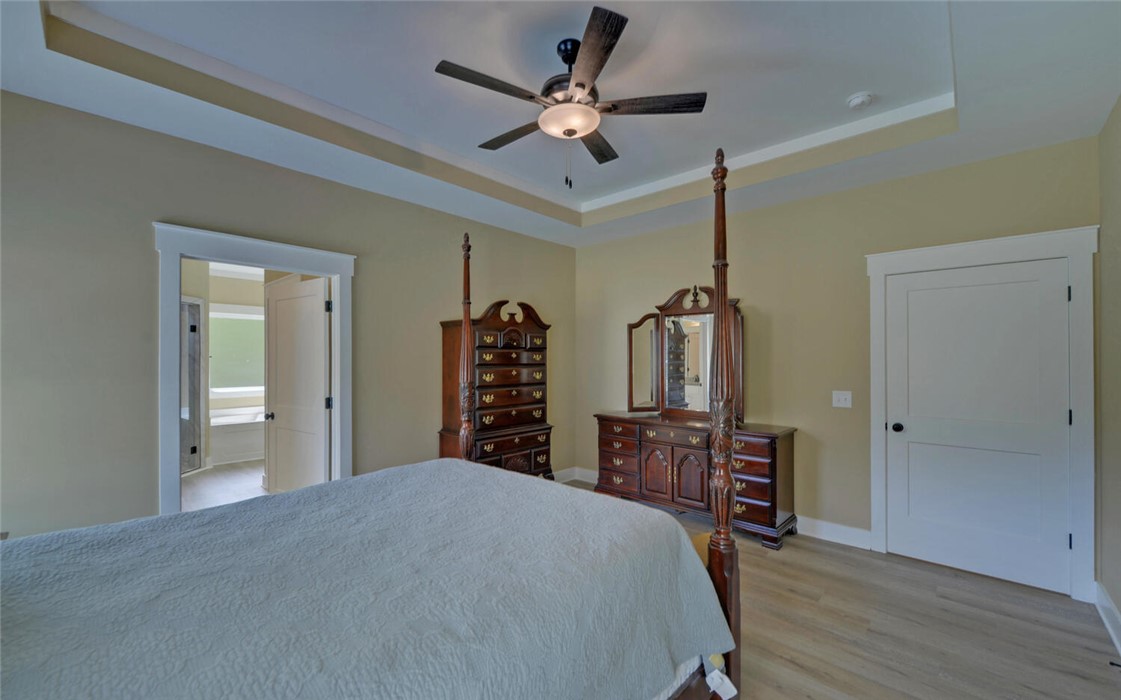 111 Topher Street Hartwell, GA 30643 - Photo 16 of 38 This spacious bedroom offers comfortable living, with a door leading to a bathroom.