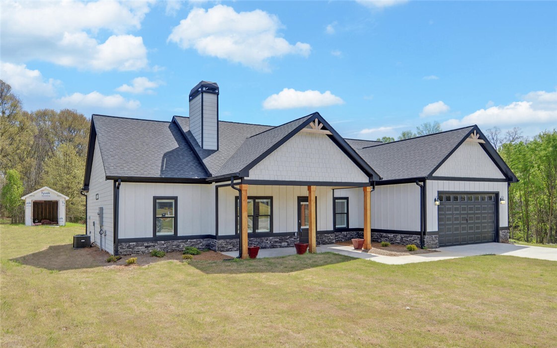 111 Topher Street Hartwell, GA 30643 - Photo 2 of 38 This charming residence features an inviting front porch and a spacious attached garage.