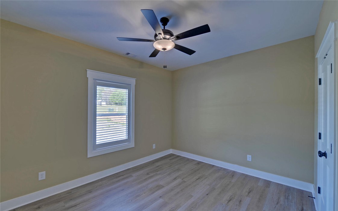 111 Topher Street Hartwell, GA 30643 - Photo 22 of 38 Bright and airy, this room features durable flooring and convenient ceiling ventilation.
