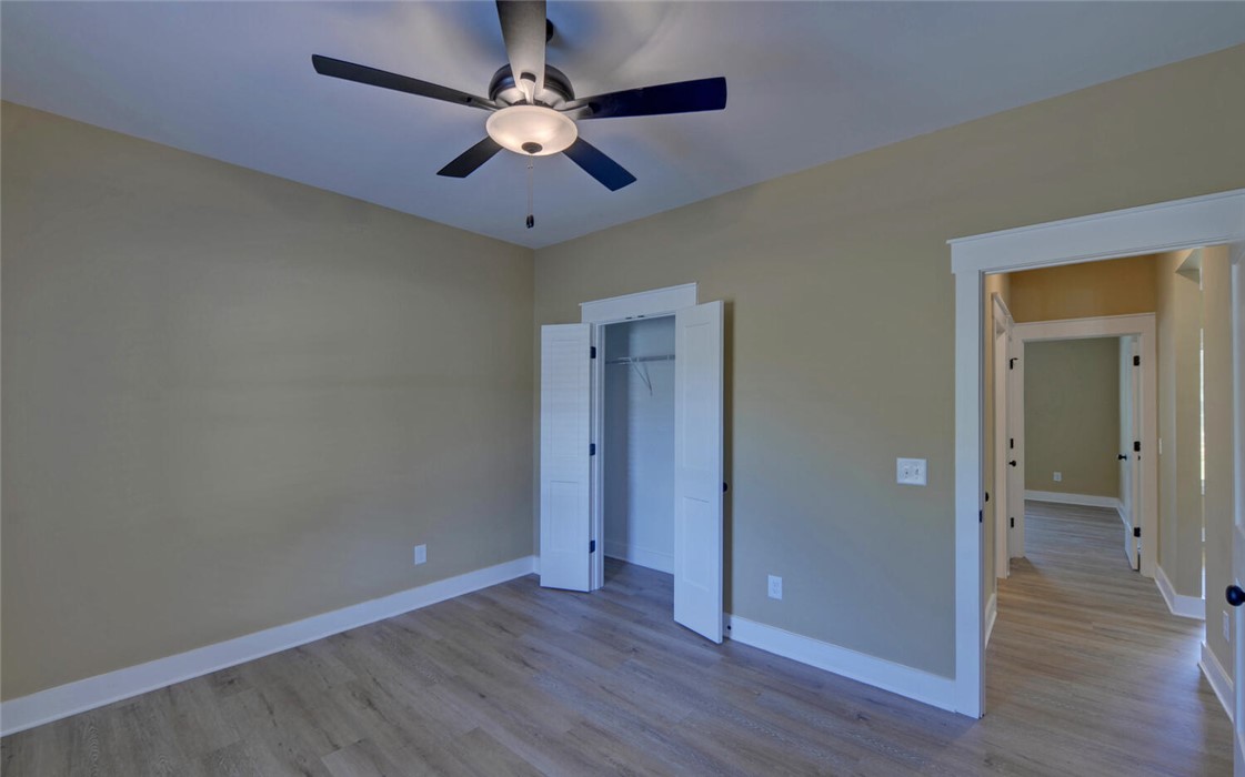 111 Topher Street Hartwell, GA 30643 - Photo 23 of 38 This airy bedroom features abundant natural light and ample space for rest and relaxation.