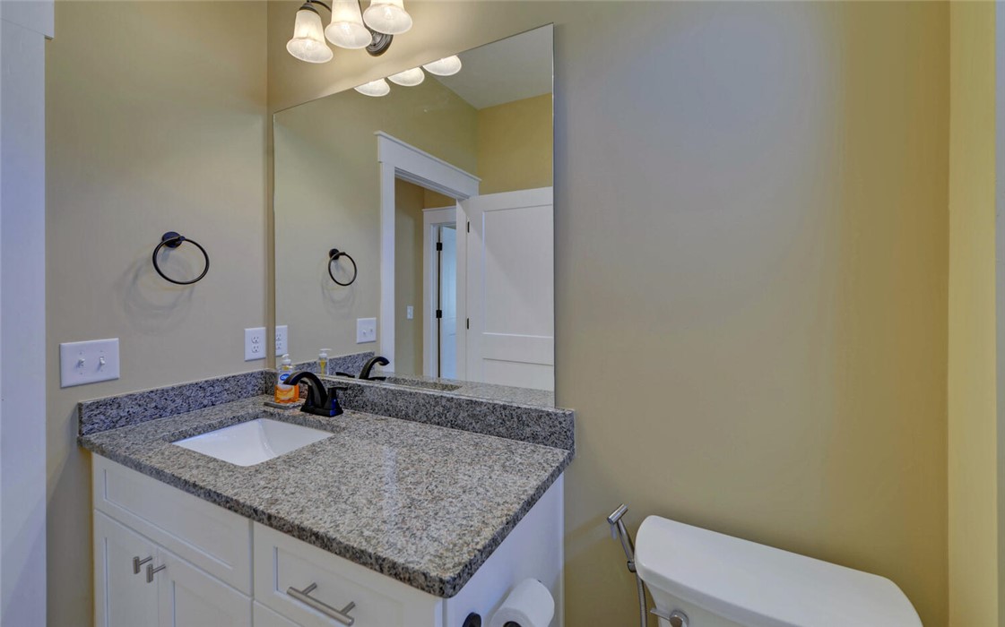 111 Topher Street Hartwell, GA 30643 - Photo 25 of 38 This clean and bright bathroom features a vanity with granite countertops and a mirror.