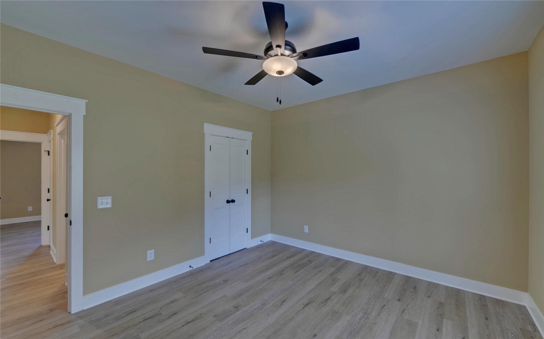 111 Topher Street Hartwell, GA 30643 - Photo 29 of 38 This spacious room features neutral tones, modern flooring, and elegant trim for versatile living.