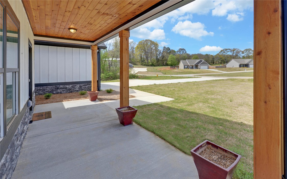 111 Topher Street Hartwell, GA 30643 - Photo 3 of 38 This inviting porch offers a tranquil retreat with a natural wood ceiling.