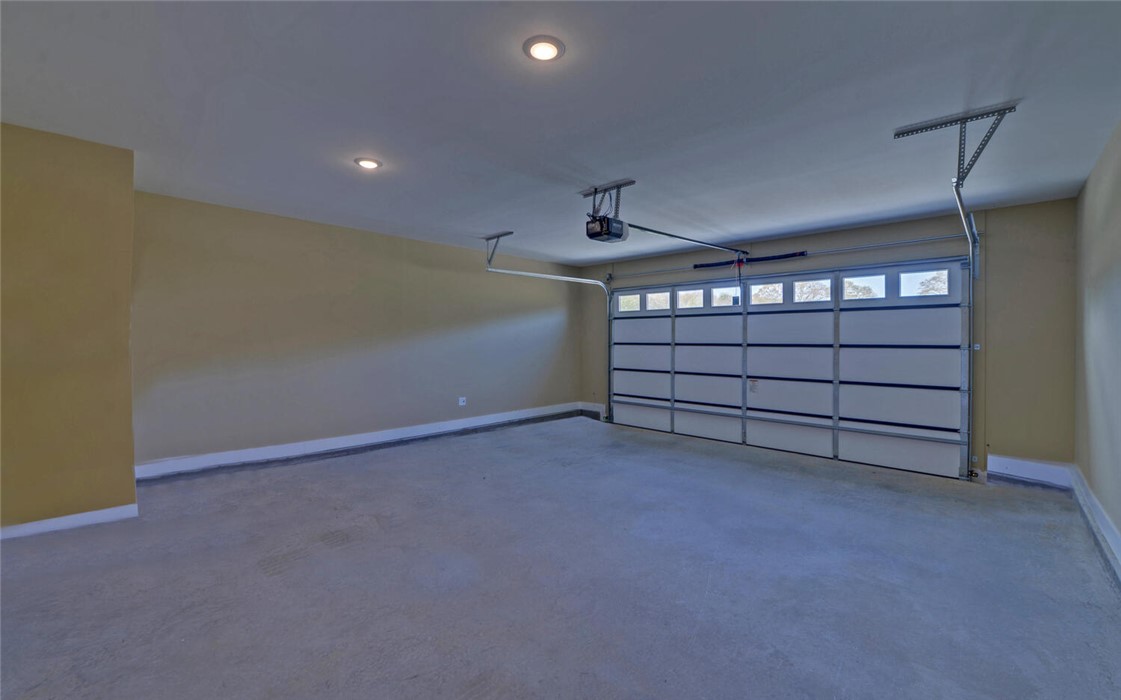 111 Topher Street Hartwell, GA 30643 - Photo 32 of 38 This spacious garage offers ample parking and storage, featuring an automatic door for effortless access.