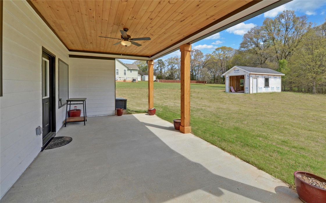 111 Topher Street Hartwell, GA 30643 - Photo 33 of 38 This spacious covered patio offers ample outdoor living space, perfect for entertaining or relaxation.