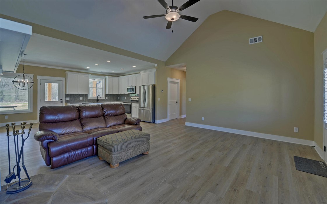 111 Topher Street Hartwell, GA 30643 - Photo 6 of 38 This inviting space combines a functional kitchen with a comfortable, open living area.